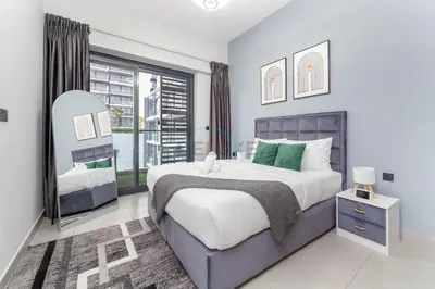 a bedroom with a large bed and a large window at Easy access to Community Parks and Green Spaces,15 minutes drive to Miracle Garden - Rigel, JVC, by Deluxe Holiday Homes in Dubai