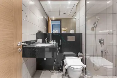 a bathroom with a sink and a toilet and a shower at Easy access to Community Parks and Green Spaces,15 minutes drive to Miracle Garden - Rigel, JVC, by Deluxe Holiday Homes in Dubai