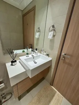 a bathroom with a white sink and a mirror at Beautiful Studio Brand New in Dubai
