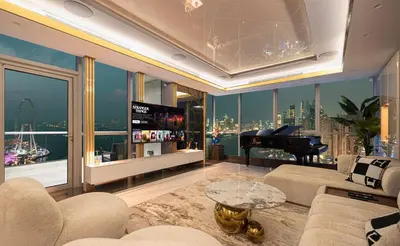 a living room with a couch and a piano at Sky Palace 3 Bedroom Penthouse on JBR in Dubai