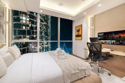 a bedroom with a bed and a desk and a window at Sky Palace 3 Bedroom Penthouse on JBR in Dubai