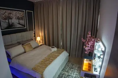 a bedroom with a bed and a vase of flowers at Bloom Tower B-Stunning View-Luxurious Furnish-Pool View in Dubai