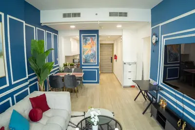 a living room with blue and white walls and a couch at Bloom Tower B-Stunning View-Luxurious Furnish-Pool View in Dubai