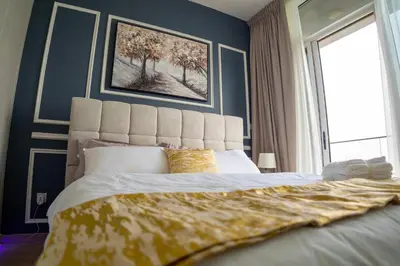 a bedroom with a large bed with a large window at Bloom Tower B-Stunning View-Luxurious Furnish-Pool View in Dubai