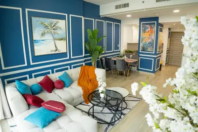 a living room with a white couch with colorful pillows at Bloom Tower B-Stunning View-Luxurious Furnish-Pool View in Dubai