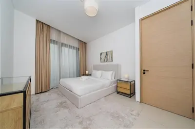 a bedroom with a white bed and a sliding door at Luxury 1 Bed Address JBR Direct Beachfront Living in Dubai