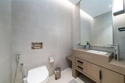 a bathroom with a white toilet and a sink at Luxury 1 Bed Address JBR Direct Beachfront Living in Dubai