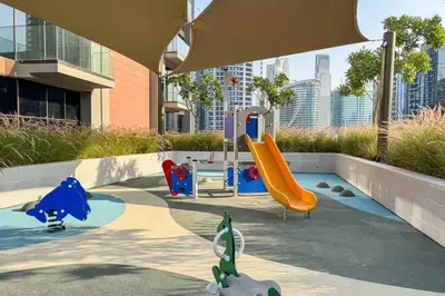 a playground with a slide in a city at Stylish Modern Peninsula One Studio, Business Bay in Dubai