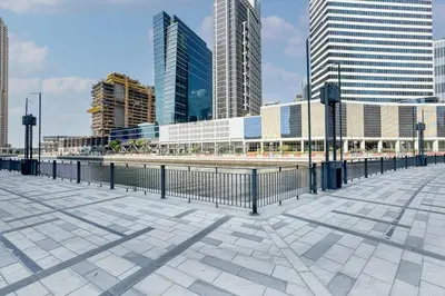 a walkway in a city with tall buildings at Stylish Modern Peninsula One Studio, Business Bay in Dubai