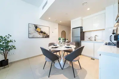 a kitchen and dining room with a table and chairs at Stylish 1 Bed in Downtown with Dubai Mall Access in Dubai