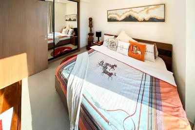 a bedroom with a bed and a mirror at Modern Place - Trillionaire Residence 608 in Dubai
