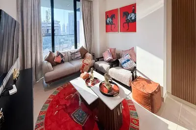 a living room with a couch and a table at Modern Place - Trillionaire Residence 608 in Dubai