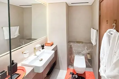a bathroom with a sink and a toilet and a mirror at Modern Place - Trillionaire Residence 608 in Dubai
