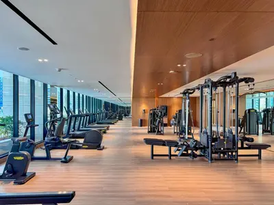a gym with treadmills and cardio equipment in a building at Modern Place - Trillionaire Residence 608 in Dubai