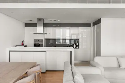 a kitchen and living room with a table and chairs at Modern 2BDR in Bluewaters Beach&Pool in Dubai