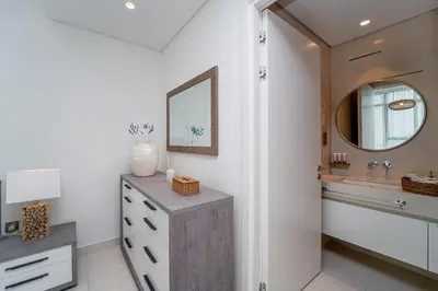 a bathroom with a sink and a mirror at 2BR with Atlantis View, Beach Access, and Infinity Pool in Dubai