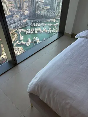 a bedroom with a large window with a view of a harbor at Marina Gate, Full Marina View, Excellent Location, Dubai Marina in Dubai Marina