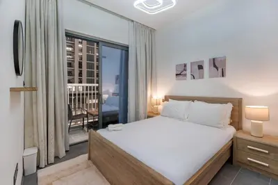 a bedroom with a bed and a balcony at Stylish Flat in Dubai in Dubai