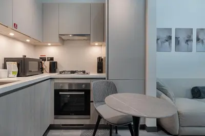 a kitchen with a table and a table and chairs at Stylish Flat in Dubai in Dubai