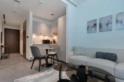 a living room with a couch and a table at Stylish Flat in Dubai in Dubai