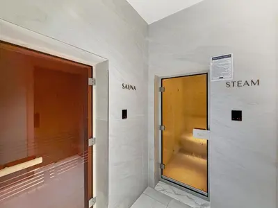 a hallway with a door and a walk in shower at Aura by Grovy 405 - Parking, Pool&Gym - by Rentujemy in Dubai