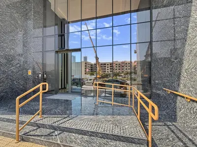 an open glass door to a building with a view at Aura by Grovy 405 - Parking, Pool&Gym - by Rentujemy in Dubai