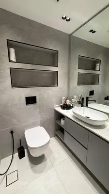 a bathroom with a white toilet and a sink at Burj, Canal & Dubai Mall Luxe Stay for 6 in Dubai