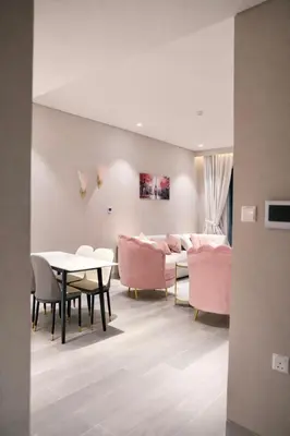 a living room with pink furniture and a table at Marina View 2BHK Luxury in Dubai