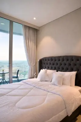 a bedroom with a large bed with a large window at Marina View 2BHK Luxury in Dubai