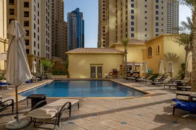 a swimming pool in a city with tall buildings at Frank Porter - Bahar 6 in Dubai