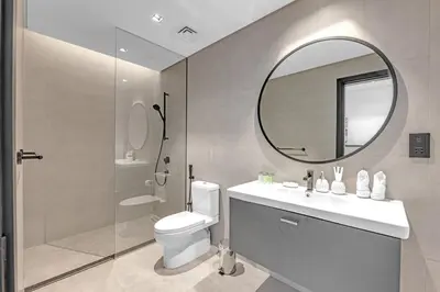 a bathroom with a toilet and a sink and a mirror at Waves - Chic Business Bay 1BR - Bright and Modern in Dubai