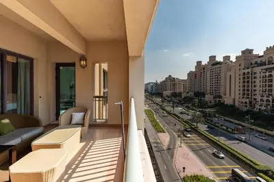 a balcony of a building with a view of a city at Walnut Palm 2BR - Palm Jumeirah in Dubai