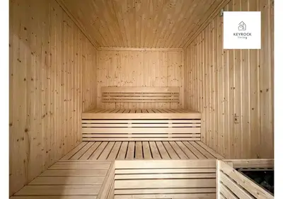 a wooden sauna with a bench in the middle at KeyRock Living - Modern 1BR at Zada Tower with Pool and Gym Facilities in Dubai
