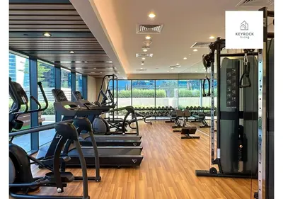 a gym with treadmills and cardio equipment in a building at KeyRock Living - Modern 1BR at Zada Tower with Pool and Gym Facilities in Dubai