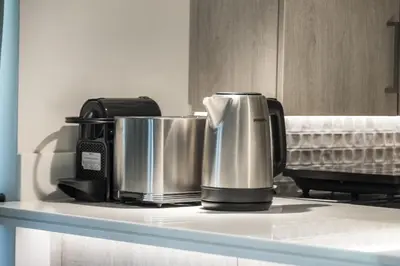 a coffee maker on a counter in a kitchen at Seven Palm Elite 1BR-Infinity Pool & Skyline Views in Dubai