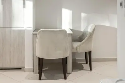 a kitchen with a desk with a chair and a refrigerator at Seven Palm Elite 1BR-Infinity Pool & Skyline Views in Dubai
