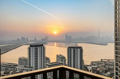 a sunset over a city with buildings and a river at Extra Luxury High Floor Skyline View Stylish in Dubai