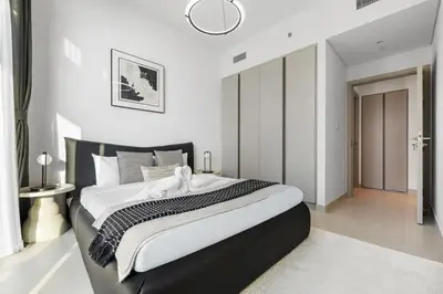 a bedroom with a large bed with a black headboard at Extra Luxury High Floor Skyline View Stylish in Dubai