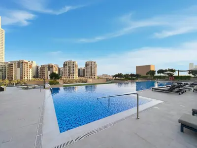 a large swimming pool with a city in the background at Extra Luxury High Floor Skyline View Stylish in Dubai