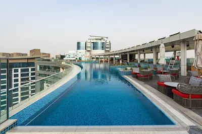 a swimming pool on the top of a building at Stylish 1-BR Beachfront Apt on SEVEN PALM Dubai in Dubai