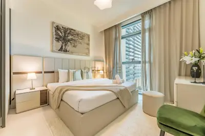 a bedroom with a bed and a large window at Steps Away From JBR Beach And Marina Promenade, Quick Access To Palm Jumeirah, Surrounded by Leisure And Entertainment Hubs - Marina Vista Tower 2, Emaar Beachfront by Deluxe Holiday Homes in Dubai