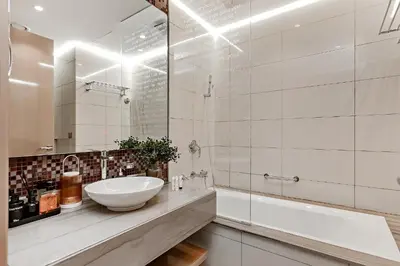 a white bathroom with a sink and a mirror at Luxury Living at Paramount Tower B, Business Bay in Dubai
