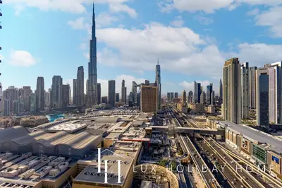 a view of a city with tall buildings and highways at LUX The Vida Burj Khalifa View Suite in Dubai