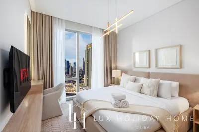 a bedroom with a large bed and a large window at LUX The Vida Burj Khalifa View Suite in Dubai
