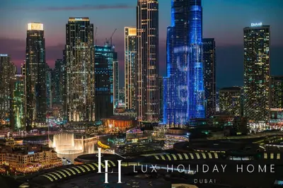 a night view of a large city with skyscrapers at LUX The Vida Burj Khalifa View Suite in Dubai