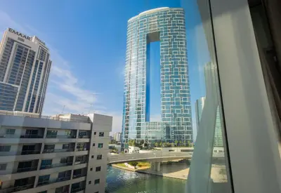 a view of a city with tall buildings and a bridge at 1BHK at Panoramic Tower, Marina with Sea and Canal View in Dubai