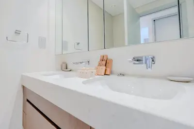 a white bathroom with a sink and a mirror at TRPS - Beach Isle Tower 1, Dubai Harbour - Seaside Residence, Private Beach, Palm View in Dubai