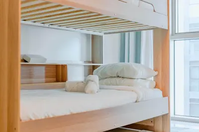 two bunk beds in a room with a window at TRPS - Beach Isle Tower 1, Dubai Harbour - Seaside Residence, Private Beach, Palm View in Dubai