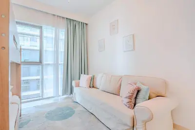 a living room with a couch and a large window at TRPS - Beach Isle Tower 1, Dubai Harbour - Seaside Residence, Private Beach, Palm View in Dubai