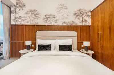 a bedroom with a large bed and two lamps at Modern 4BR Suite Overlooking Downtown in Dubai